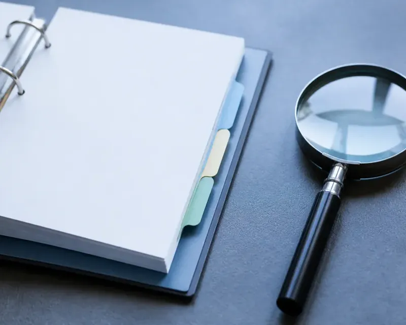 An organised overview of printed documents fanned out on a desk